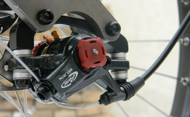  - The Avid BB7 calipers has tremendous stopping power and are easy to adjust. The inner brake pad can be adjsuted with the smaller red knob, while the outer pad is adjusted with the larger red knob on the backside of the caliper.