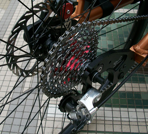 Rear Gearing - The SRAM PG-990 is lightweight aluminum and runs very quiet. The anodized red spacers add a nice effect.