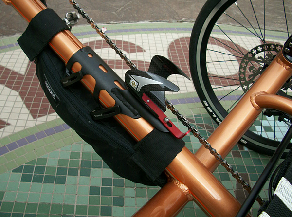 Water Bottle Cage - I went with the carbon fiber Origin8 water bottle cage mainly because I needed some anodized red to balance the front of the trike out. I've used these in the past and they work great on a boom.