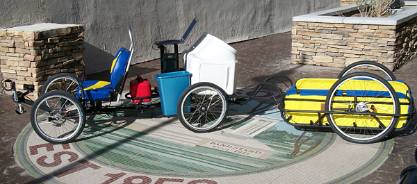 Trailer - Sharon wants to take her dogs with her on her cross-country trip. She will tow them in the trailer and store dog food in the white large bins. To accommodate the large bins we made a custom platform and welded it to the rear of the gas motor.